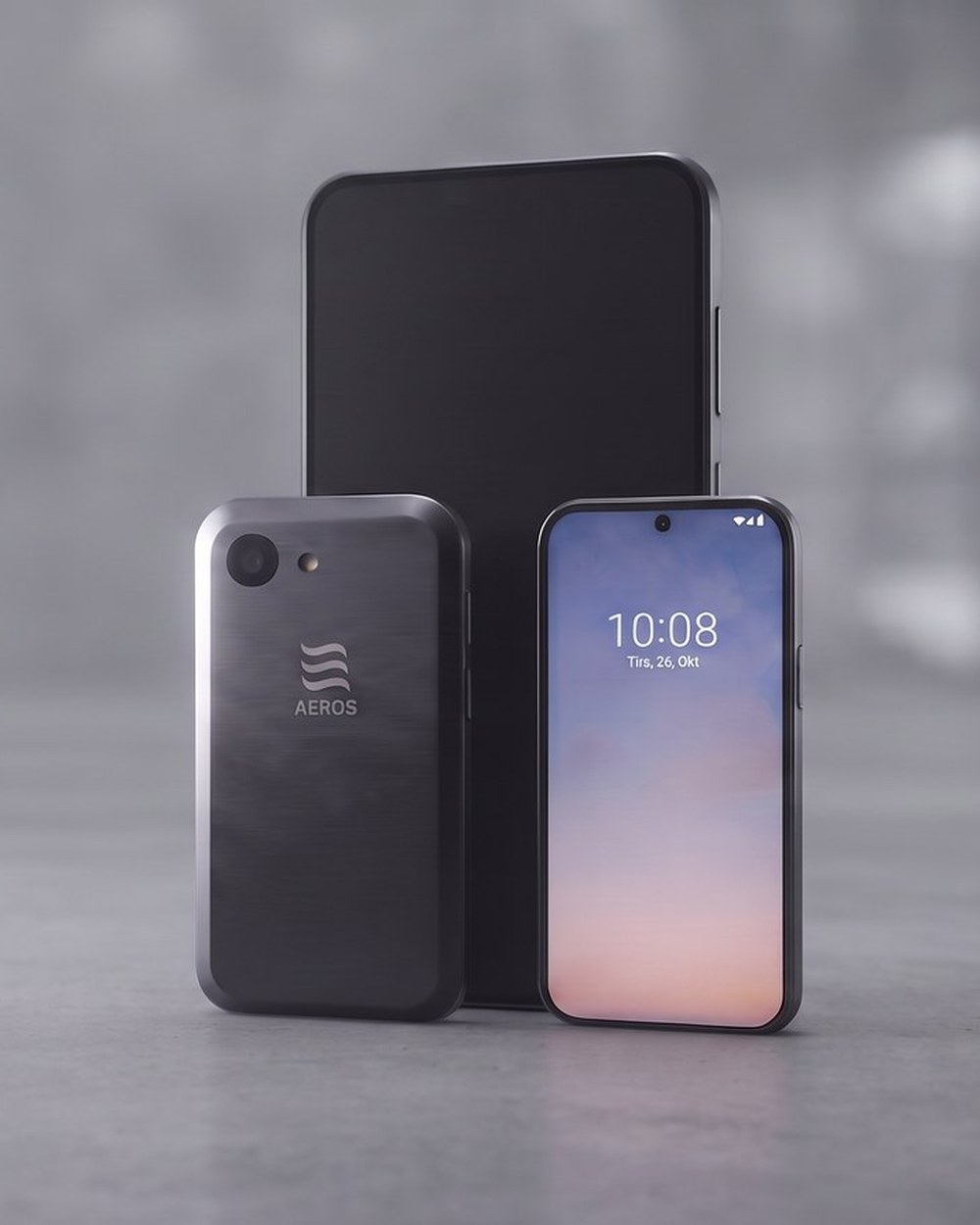 The concept phone shown front and back beside a current flagship, in a concrete hall